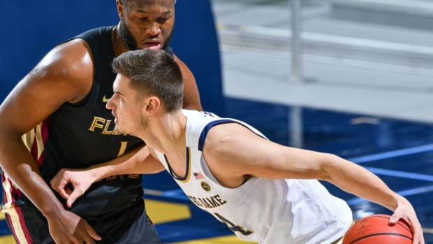 Mar 6, 2021; South Bend, Indiana, USA; Notre Dame Fighting Irish forward Nate Laszewski (14) dribbles as Florida State Seminoles forward Raiquan Gray (1) defends in the first half at the Purcell Pavilion. Mandatory Credit: Matt Cashore-USA TODAY Sports